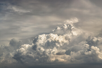 The sun shines through the clouds in the sunset sky with dramatic light. The shape of the clouds evokes imagination and creativity. They can be used as wallpapers that look amazing. Copy space.