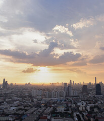 Bangkok, Thailand - Aug 17, 2021: Gorgeous panorama scenic of the sunrise or sunset with cloud on the orange and blue sky over large metropolitan city in Bangkok. Copy space, Selective focus.