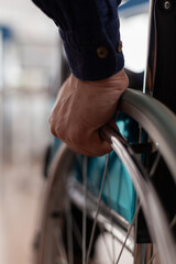 Closeup of disabled paralyzed businessman hands in wheelchair working at management strategy in...