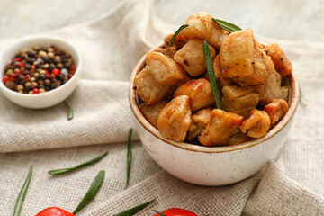 Bowl with tasty cracklings on table
