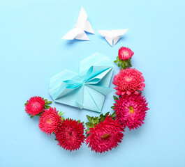 Composition with aster flowers, origami butterfly and heart on color background