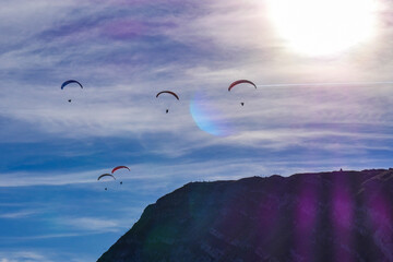 Paraglider flying over mountains in summer day in front of the mountain, High quality photo