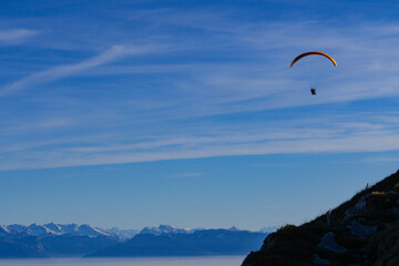 Paraglider flying over mountains in summer day in front of the mountain, High quality photo