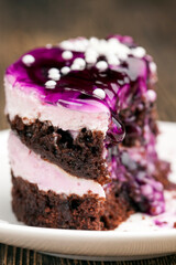 chocolate cake with cream covered with blueberry jam