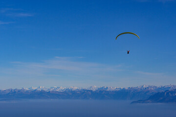 Paraglider flying over mountains in summer day in front of the mountain, High quality photo