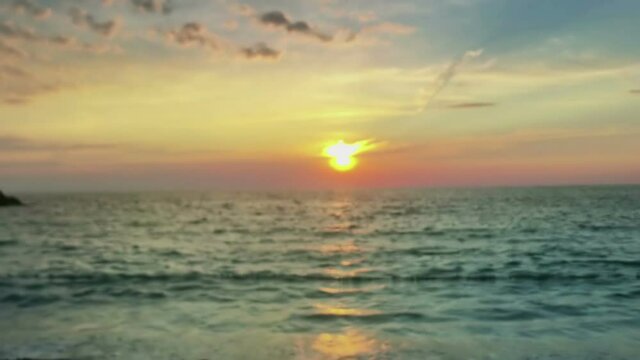 hand holding magic crystall ball over beautiful nature landscape on sunset, travel concept