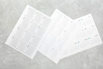 Different paper calendars on grunge background