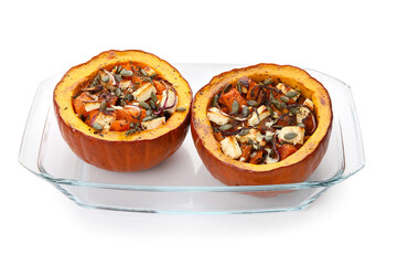 Baking dish with tasty stuffed pumpkins on white background