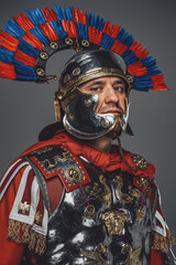 Headshot of isolated on gray roman warrior with plumed helmet