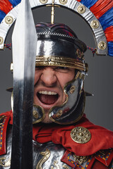 Screaming legionary with short sword against gray background