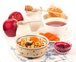 Healthy breakfast. Bowl of yogurt with granola, dried apricots and apples