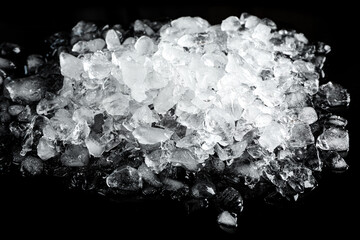 Heap of crushed ice on black table