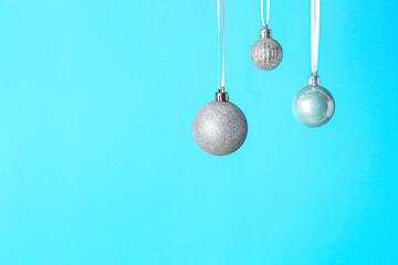 Silver Christmas balls on color background