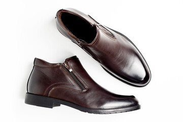 Leather brown men's shoes with a zipper lock isolated on a white background. Pair of men's shoes. Top view, flat lay.