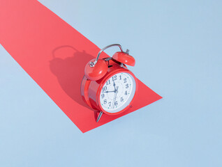 red retro clock and red paper with copy space against pastel blue background. abstract art. minimalism