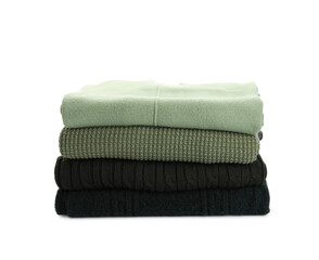 Stack of stylish green sweaters on white background