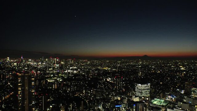 TOKYO, JAPAN : Aerial high angle sunset CITYSCAPE of TOKYO. View of buildings around Shinjuku and Nakano ward. Japanese city life, business and urban metropolis concept. Real time fixed shot.