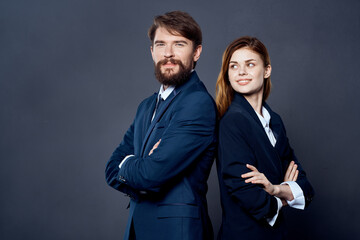 cheerful man and woman work colleagues team dark background
