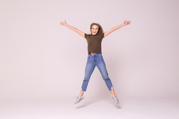 Portrait of a cheerful cute woman jumping on a white background