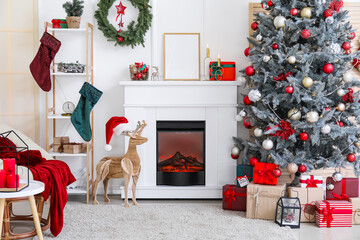 Obraz premium Beautiful Christmas tree, armchair and fireplace in decorated living room