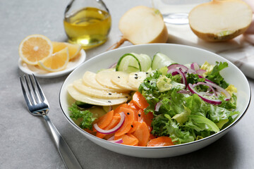 Fresh turnip salad served on grey table