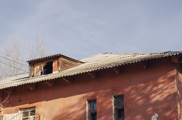 Fototapeta na wymiar The top of an old house with a slate roof.