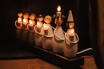 Christmas decoration. Small wooden little men with lamps. Cute toys. - Powered by Adobe