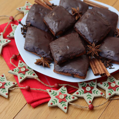 Italian traditional festive cookies called Mostaccioli or Mustaccioli on a plate on red napkin with...