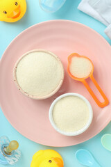 Concept of baby food with рowdered milk on blue background