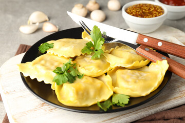 Delicious food concept with ravioli on gray background