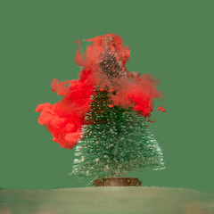 Surreal snowy Christmas tree with red snow against pastel blue backgroud. Jungle futurism modern...