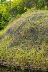 Chain link mesh slope protection netting on Monte Ruke near Sauris di Sopra, Udine Province,...