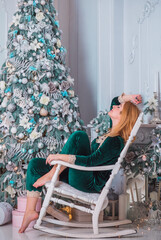 Nice young plus size European or American lady at Christmas time. Pretty cozy home holidays atmosphere