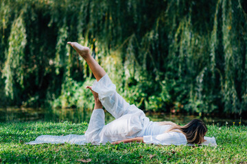 Yoga. Woman Doing Yoga by the Lake.