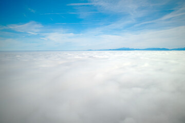 Sea of fog with Swiss alps in the background and cloudy blue sky on a autumn day. Photo taken November 19th, 2021, Zurich, Switzerland.