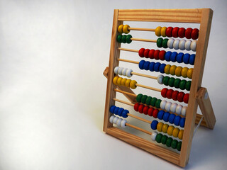 on the right, wooden children's abacus stand on a gray background, side view.  preschool education for children