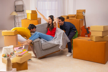 Adult boys and girl having fun during house shifting