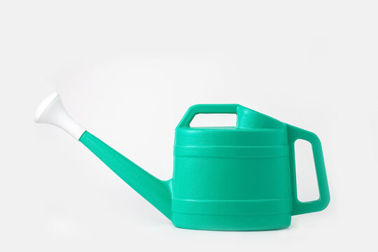 Green plastic garden watering can, isolated on white background.Top view.High resolution photo.
