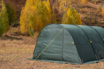 Large basecamp tents on colorful mountains background.