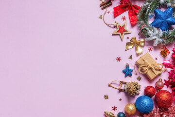 christmas decorations and tree toys on pink background with place for text