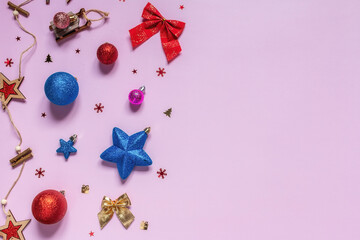 Christmas toys and Christmas decorations on a pink background with place for text