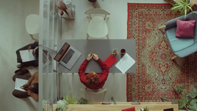 Top down shot of female HR manager conducting job interview with candidate in office