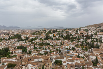 Fototapeta na wymiar Aerial view at the main Granada cityscape, view from the Alhambra citadel palace lookout, architecture buildings and horizon, Spain
