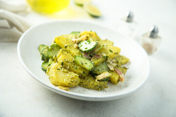 Homemade potato salad with pesto and bacon