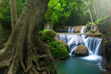 Landscape of pure tropical waterfall on rainy morning.