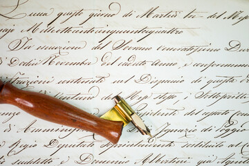Close-up detail of a wooden oblique penholder over a manuscript 