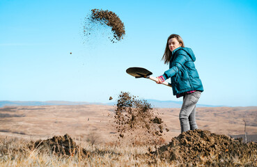 Woman using shovel on the field