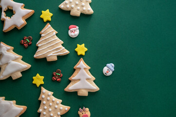 Christmas tree cookies with icing and stars. Festive winter pastry, home baking concept, green...