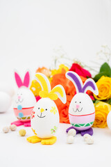 Easter bunny eggs with colorful flowers on background. Abstract Easter concept.