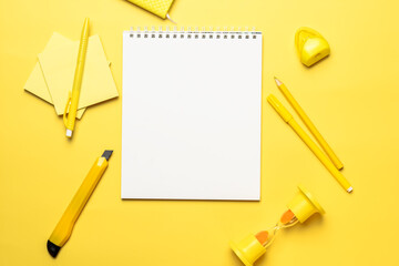 white sheet of paper in a notebook with objects for office work, pen, pencil, sharpener, knife and...